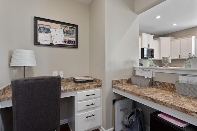 home office with recessed lighting and built in desk