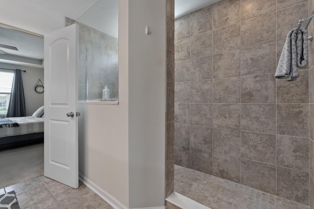 ensuite bathroom featuring ensuite bathroom, baseboards, a walk in shower, and tile patterned flooring
