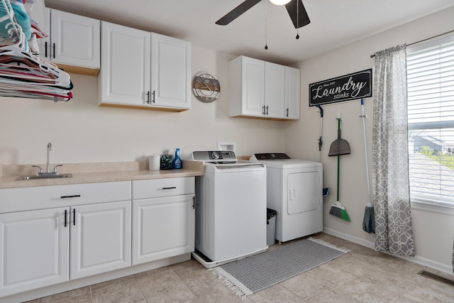 clothes washing area featuring independent washer and dryer, cabinet space, a sink, a ceiling fan, and visible vents