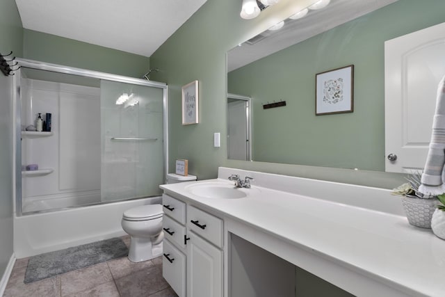 bathroom featuring vanity, combined bath / shower with glass door, tile patterned flooring, and toilet