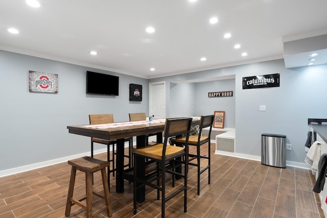 dining room with recessed lighting, ornamental molding, baseboards, and wood tiled floor