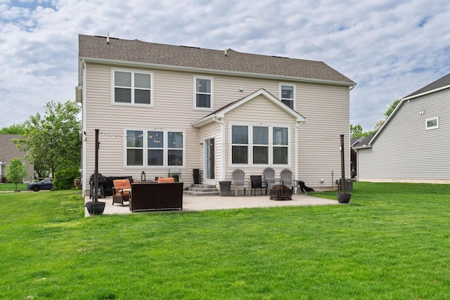 rear view of property featuring a yard, a patio, entry steps, and an outdoor living space with a fire pit