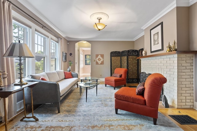 47 Richards Rd, Columbus, OH 43214 - living area featuring a brick fireplace, arched walkways, wood finished floors, visible vents, and ornamental molding