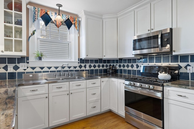 47 Richards Rd, Columbus, OH 43214 - kitchen featuring stainless steel countertops, tasteful backsplash, a sink, white cabinets, and stainless steel appliances