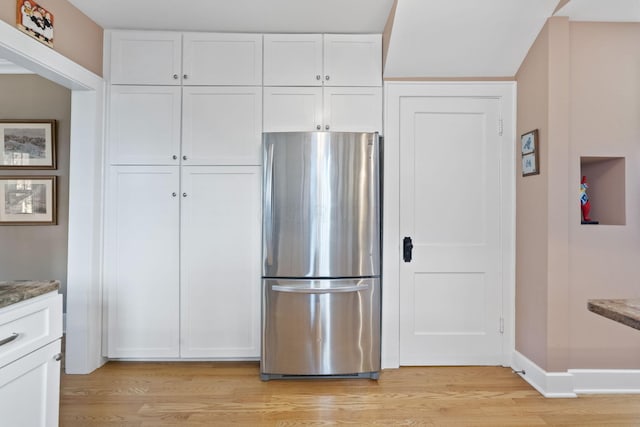 47 Richards Rd, Columbus, OH 43214 - kitchen featuring light wood-type flooring, freestanding refrigerator, white cabinetry, and baseboards
