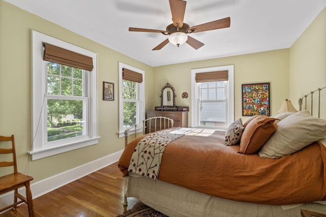 47 Richards Rd, Columbus, OH 43214 - bedroom with baseboards, ceiling fan, wood finished floors, and multiple windows