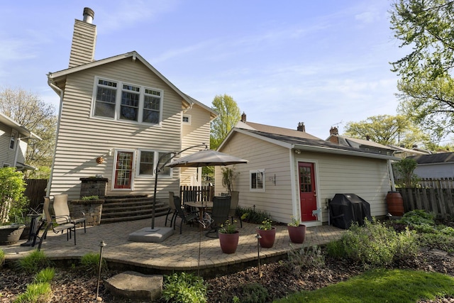 47 Richards Rd, Columbus, OH 43214 - back of house with fence, a chimney, and a patio area