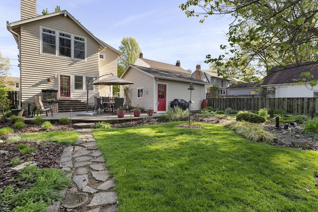 47 Richards Rd, Columbus, OH 43214 - back of house featuring a yard, fence, a chimney, and a patio area