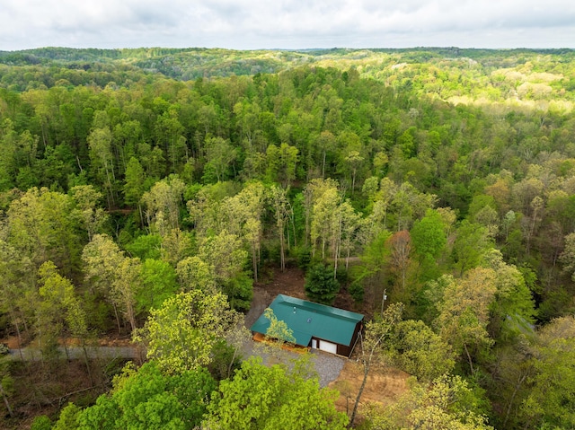 drone / aerial view featuring a forest view