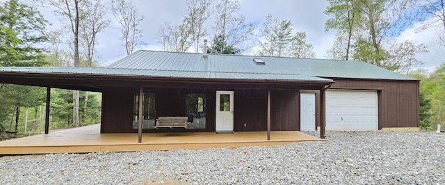rear view of property with metal roof