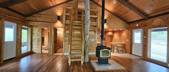interior space with wooden ceiling, wooden walls, and beamed ceiling