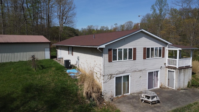 back of property with a yard, a patio, and central air condition unit