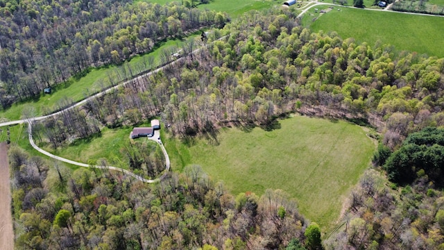 drone / aerial view featuring a rural view and a wooded view