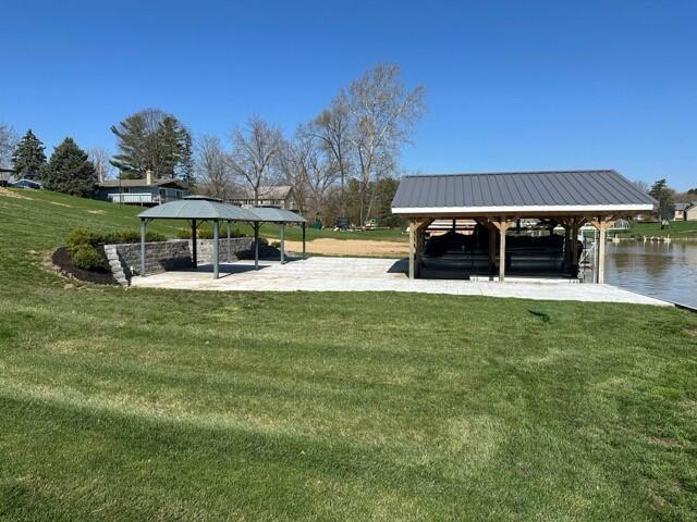 view of home's community featuring a water view, a gazebo, and a yard