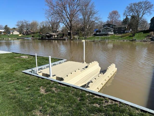 view of dock featuring a yard and a water view