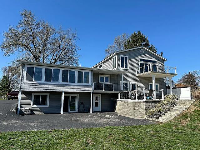 back of property with a lawn and a patio