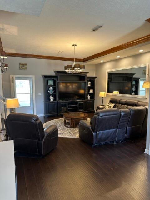 living area featuring recessed lighting, ornamental molding, a chandelier, and hardwood / wood-style floors