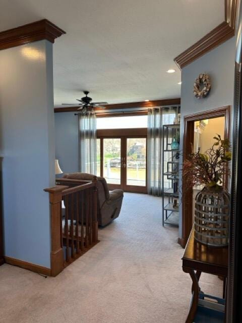 living room with ceiling fan, french doors, light colored carpet, crown molding, and baseboards