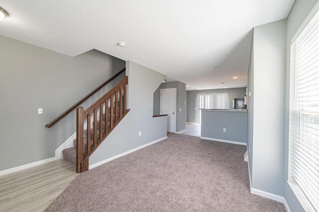 6388 Loblolly Dr, Canal Winchester, OH 43110 - unfurnished living room featuring baseboards, carpet flooring, stairs, and recessed lighting