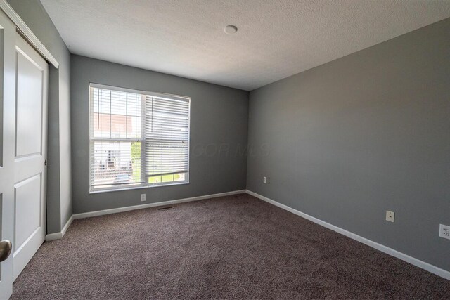6388 Loblolly Dr, Canal Winchester, OH 43110 - carpeted empty room featuring a textured ceiling, baseboards, and visible vents