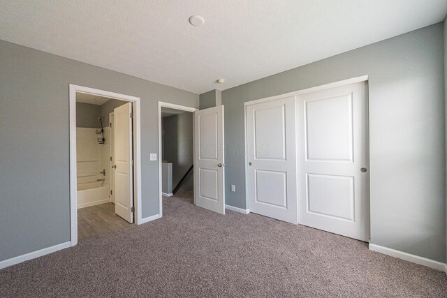 6388 Loblolly Dr, Canal Winchester, OH 43110 - unfurnished bedroom featuring a closet, baseboards, ensuite bathroom, and carpet flooring