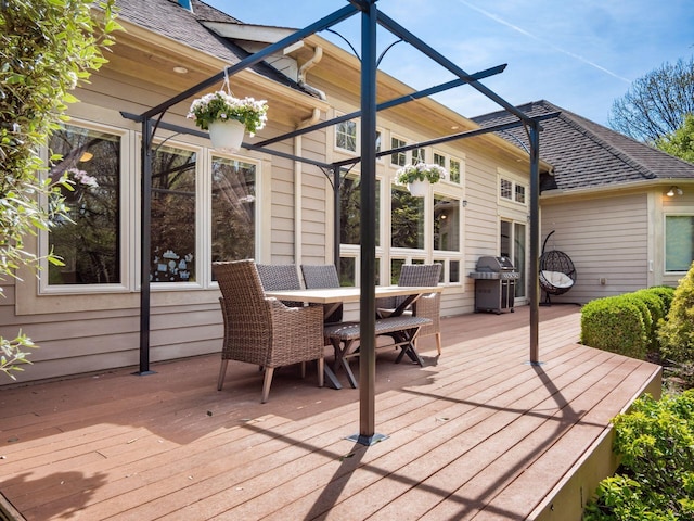deck featuring grilling area and outdoor dining space