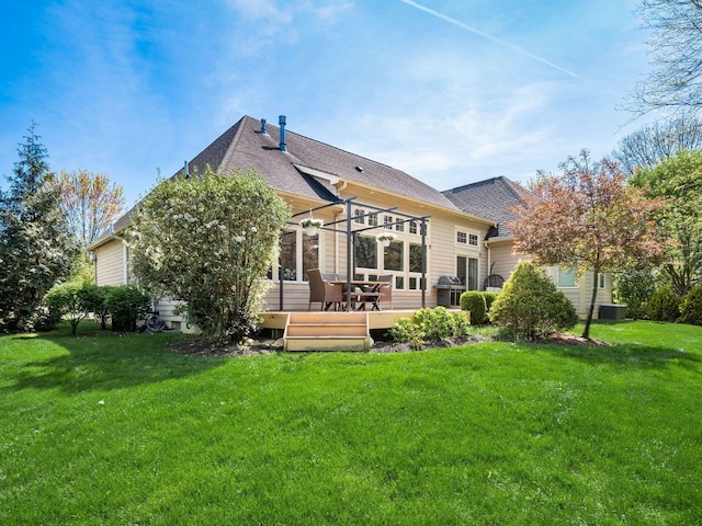 back of property featuring a shingled roof, a yard, and central AC unit