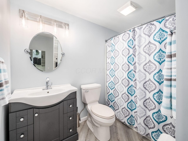 full bathroom featuring toilet, visible vents, curtained shower, vanity, and wood finished floors