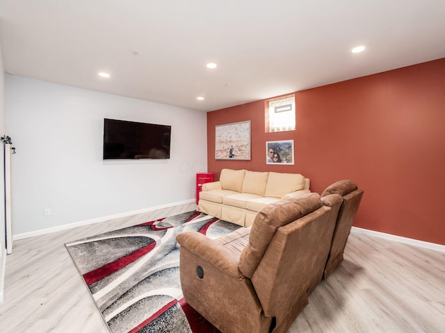 living area featuring baseboards, light wood-style flooring, and recessed lighting
