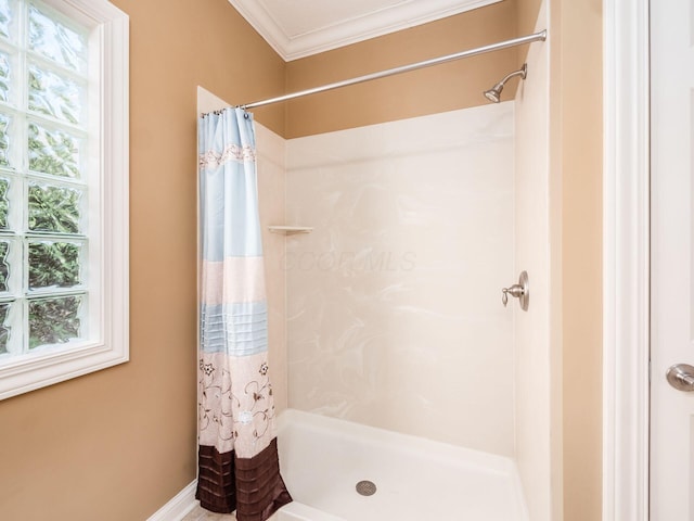 bathroom featuring ornamental molding, plenty of natural light, and a shower with shower curtain