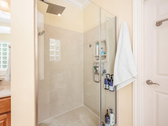 full bathroom with crown molding, tile patterned flooring, a shower stall, and vanity
