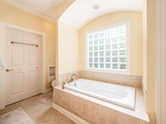 bathroom featuring tile patterned floors, a garden tub, and toilet