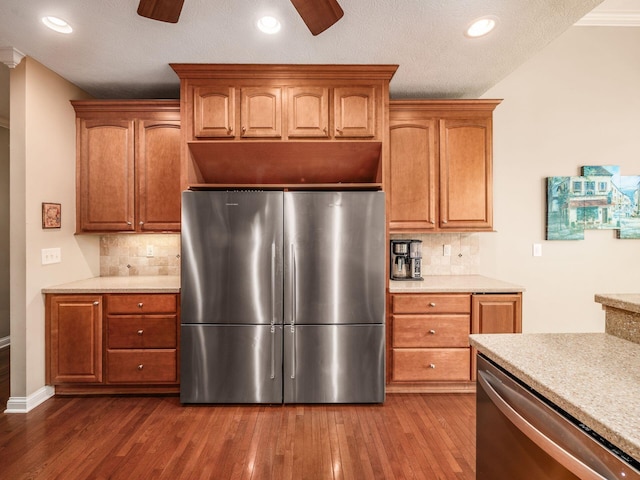 kitchen featuring light countertops, stainless steel appliances, ceiling fan, and decorative backsplash