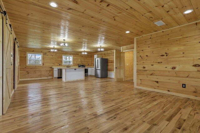 7435 Baltimore Somerset Rd NE, Thornville, OH 43076 - unfurnished living room with light wood-style floors, wood walls, wood ceiling, and recessed lighting