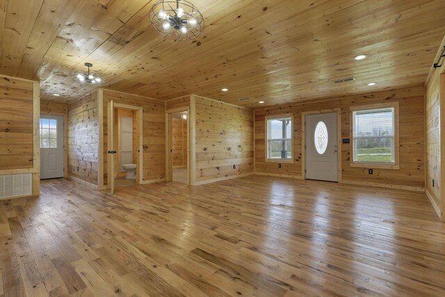 7435 Baltimore Somerset Rd NE, Thornville, OH 43076 - interior space featuring wood walls, a notable chandelier, wood ceiling, and light wood finished floors