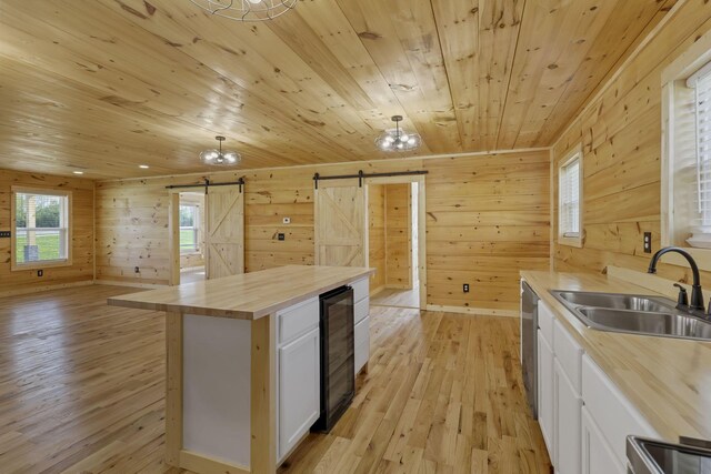 7435 Baltimore Somerset Rd NE, Thornville, OH 43076 - kitchen with a barn door, a sink, light wood finished floors, butcher block counters, and wine cooler