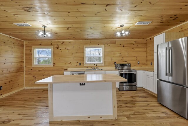 7435 Baltimore Somerset Rd NE, Thornville, OH 43076 - kitchen with a sink, appliances with stainless steel finishes, a healthy amount of sunlight, and a notable chandelier