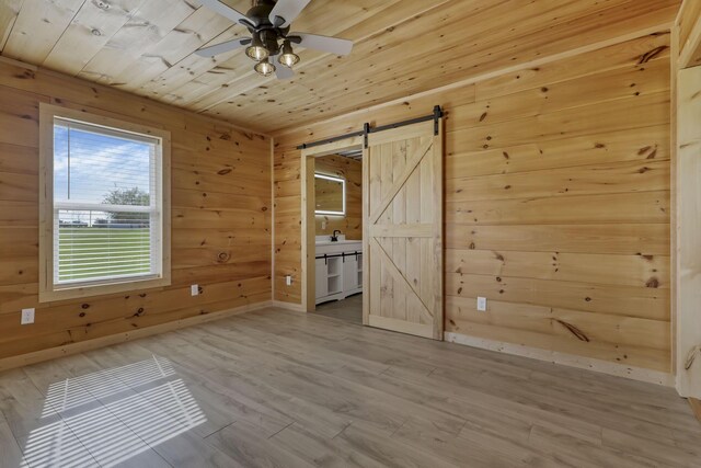 7435 Baltimore Somerset Rd NE, Thornville, OH 43076 - unfurnished room with wooden walls, wooden ceiling, a barn door, and wood finished floors