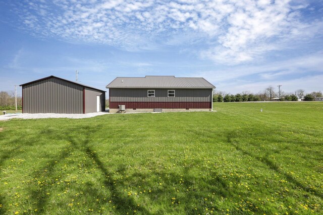 7435 Baltimore Somerset Rd NE, Thornville, OH 43076 - rear view of property with a lawn, an outbuilding, a pole building, and metal roof