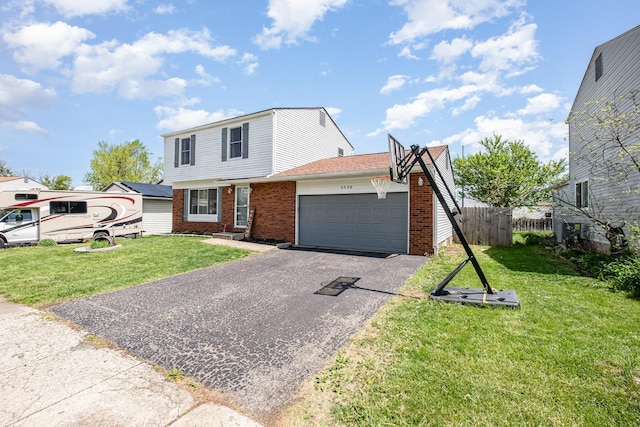 view of front of house with driveway, a front yard, brick siding, fence, and an attached garage