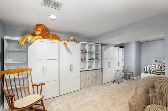 bedroom featuring light carpet and visible vents