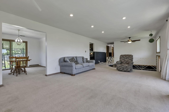 living area with light carpet, baseboards, baseboard heating, recessed lighting, and ceiling fan with notable chandelier