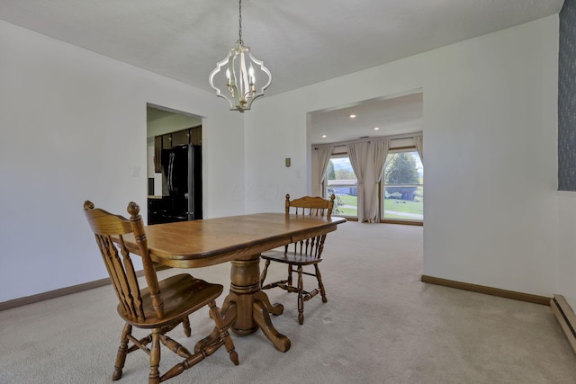 dining area featuring recessed lighting, baseboards, an inviting chandelier, and light carpet