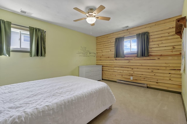 bedroom featuring wooden walls, visible vents, baseboard heating, and carpet