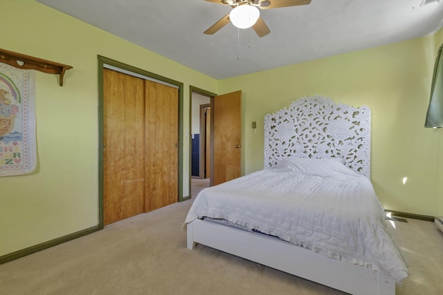 bedroom with carpet floors, a ceiling fan, baseboards, and a closet