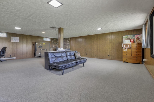 interior space with a textured ceiling, wood walls, and plenty of natural light