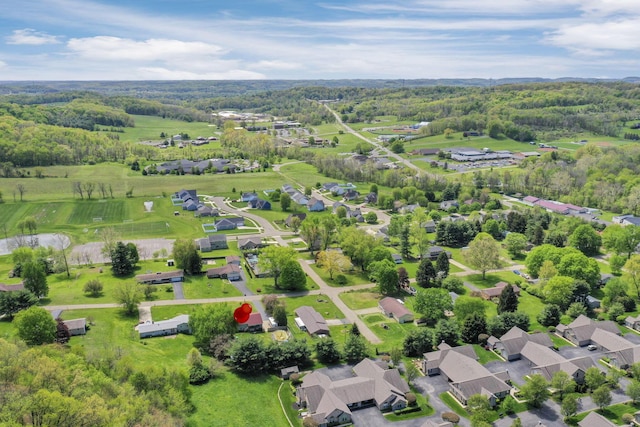 bird's eye view with a wooded view and a residential view