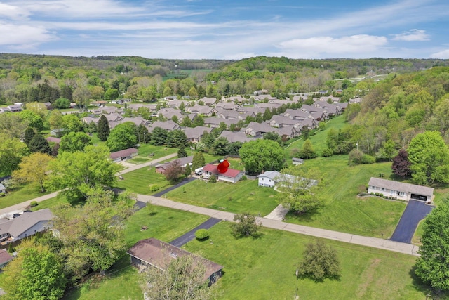 birds eye view of property featuring a residential view and a forest view