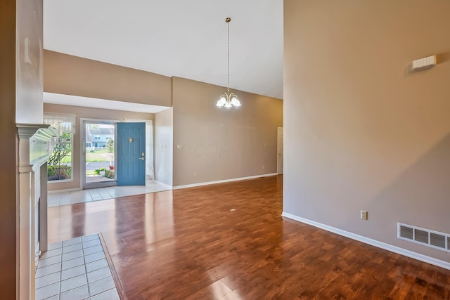 interior space with wood finished floors, baseboards, a chandelier, and visible vents