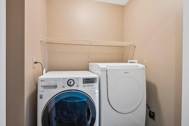 laundry area featuring separate washer and dryer and laundry area